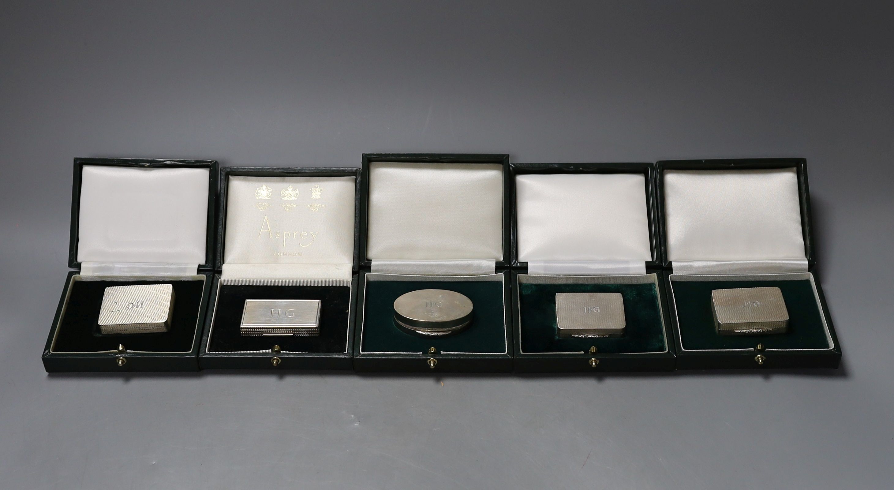 Six assorted modern cased silver or parcel gilt silver pill boxes by Peter John Doherty, Birmingham, 1969-1996, largest 5cm, all in fitted Gallagher boxes, one by Asprey.